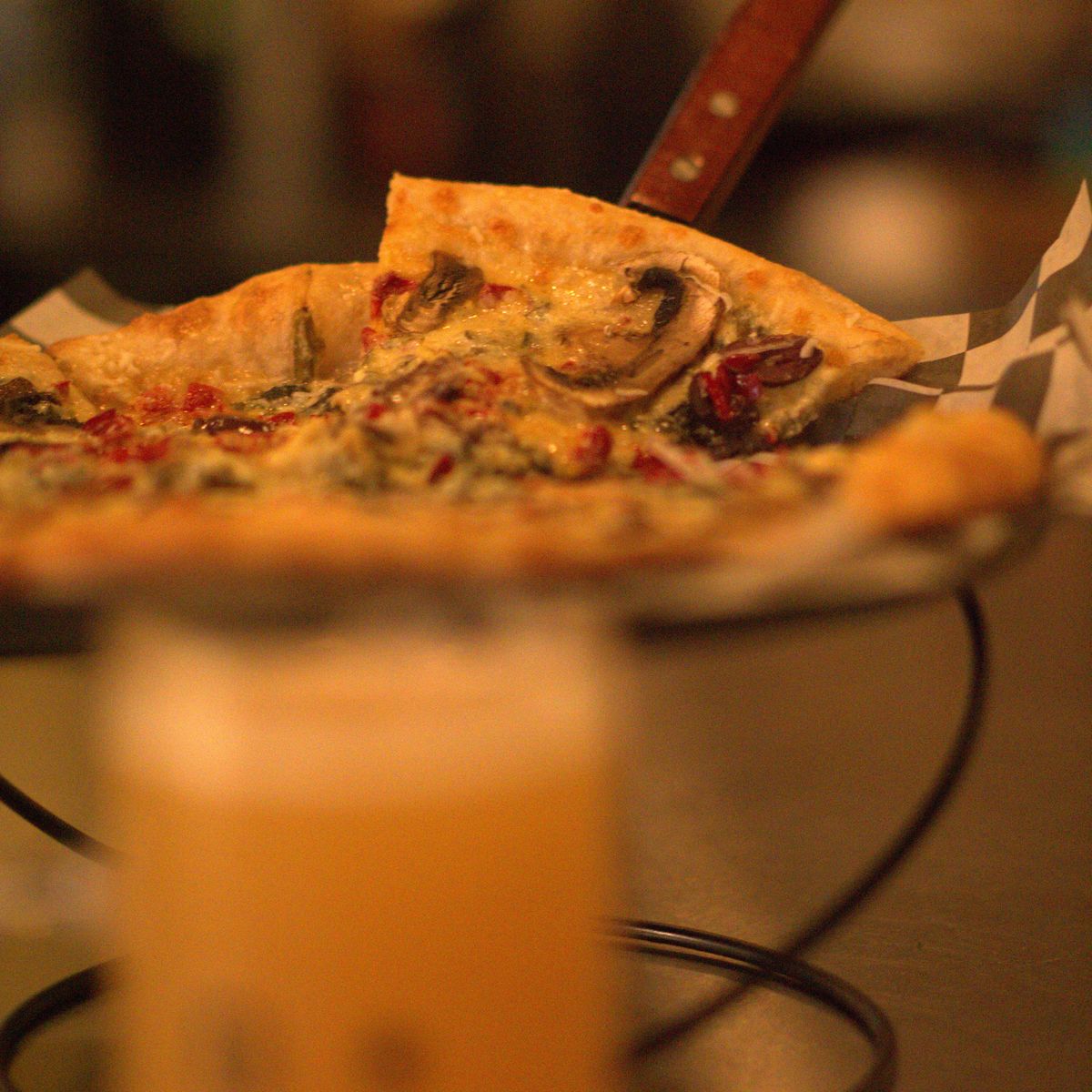 Pizza and a cold beer at the bar after dark